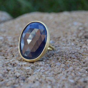 Custom designed sapphire slice ring in yellow gold with satin finish