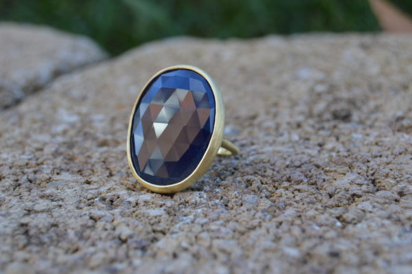 Custom designed sapphire slice ring in yellow gold with satin finish