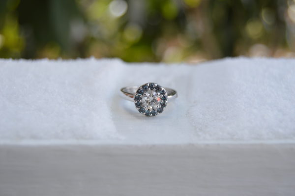 Custom designed round diamond engagement ring with alexandrite halo