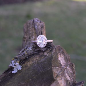 Oval diamond halo engagement ring in rose gold