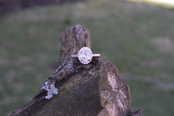 Oval diamond halo engagement ring in rose gold