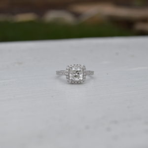 Cushion shaped diamond halo engagement ring in white gold