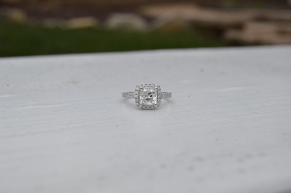 Cushion shaped diamond halo engagement ring in white gold