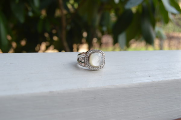 Custom designed mother of pearl and diamond halo ring with split shank