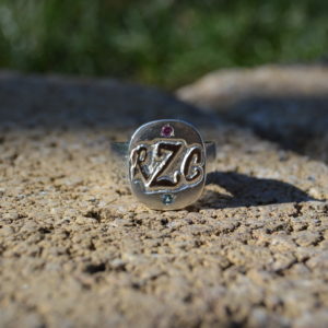 Custom designed two tone family ring with initials and gemstones