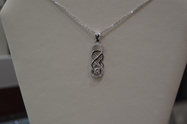 Custom designed double infinity and diamond pendant in white gold
