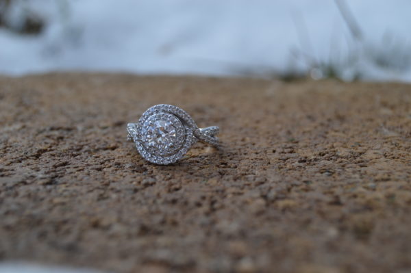 Custom designed round diamond engagement ring with twist halo