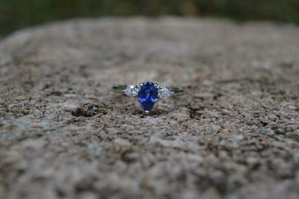 Custom designed lady's ring with pear shaped sapphire and pear shaped diamonds in white gold