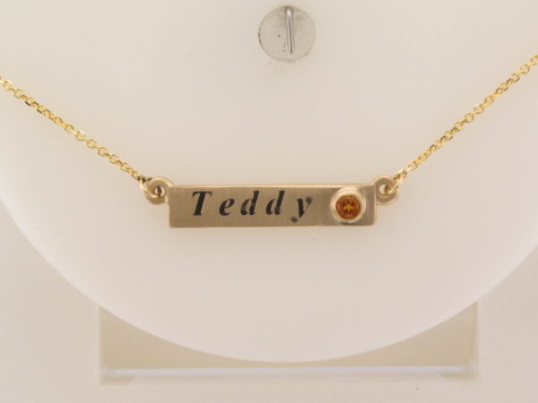 Custom designed yellow gold bar pendant with name and birthstone