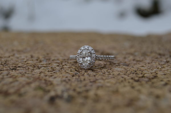 Custom designed oval diamond halo engagement ring in white gold
