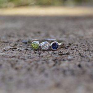 Custom Designed Family Ring with Round Bezel Set Peridot, Diamond and Sapphire