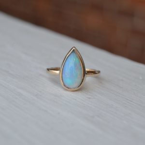 Custom Designed Pear Shaped Opal Ring in Yellow Gold