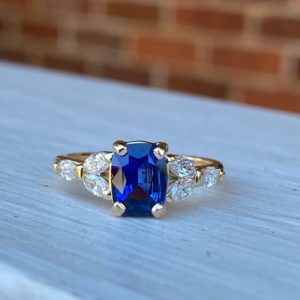 Custom Designed Cushion Sapphire Ring with Marquise Diamonds in Yellow Gold