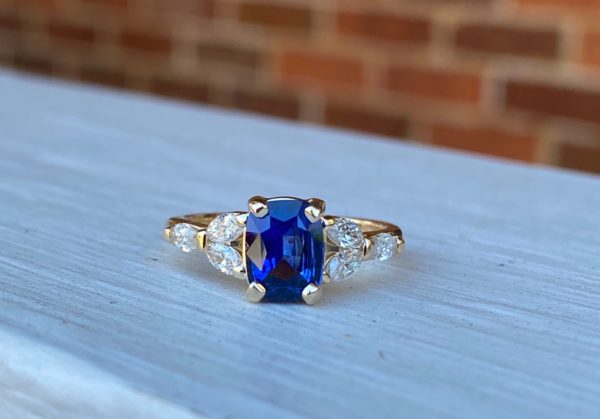 Custom Designed Cushion Sapphire Ring with Marquise Diamonds in Yellow Gold