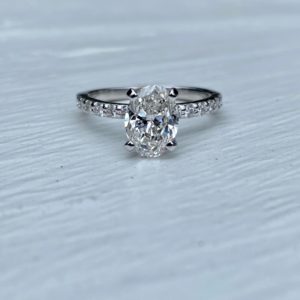 Oval Diamond Engagement Ring with Ideal Cut Round Diamonds in Shared Prong Shank