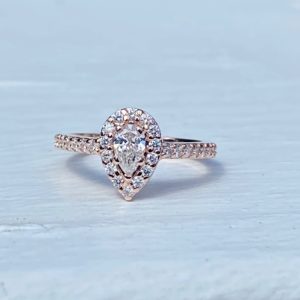 Custom Designed Rose Gold Pear Shaped Halo Engagement Ring with Diamond Shared Prong Shank