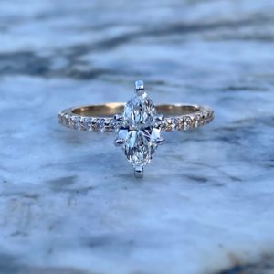 Custom Designed Marquise Diamond Solitaire with Round Diamonds in Shared Prong Shank