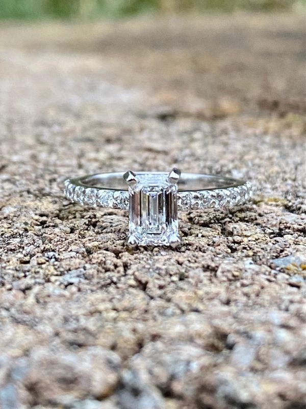 Custom Designed Emerald Cut Diamond Solitaire with Round Diamonds in Shared Prong Shank