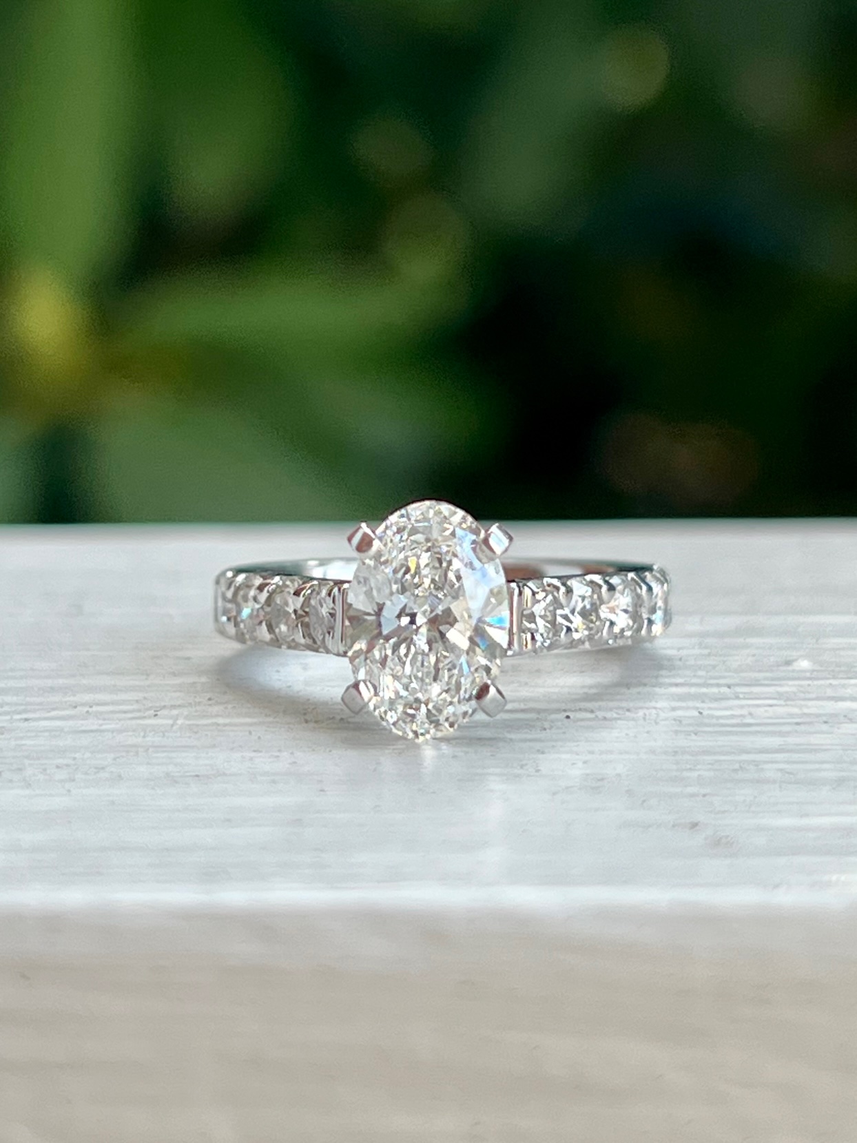 Custom Designed Engagement Ring with Oval Prong Set Center and Round Diamonds in Shared Prong Shank