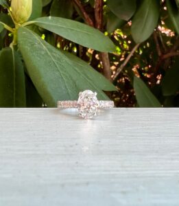 Custom Designed Oval Diamond Solitaire Engagement Ring with Round Diamonds in Shared Prong Shank