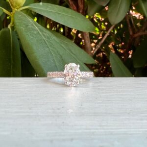 Custom Designed Oval Diamond Solitaire Engagement Ring with Round Diamonds in Shared Prong Shank